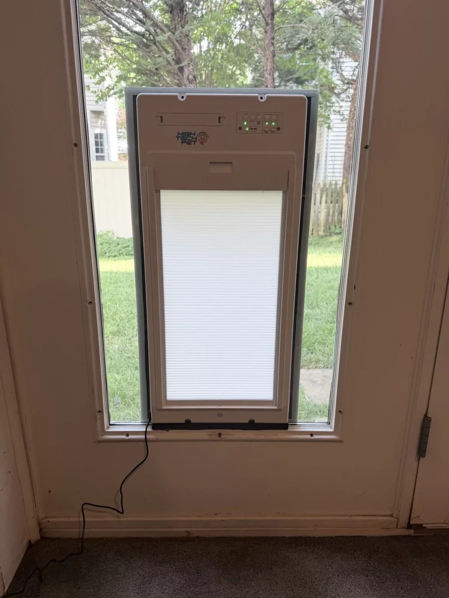 Installed electronic pet door in a residential door window