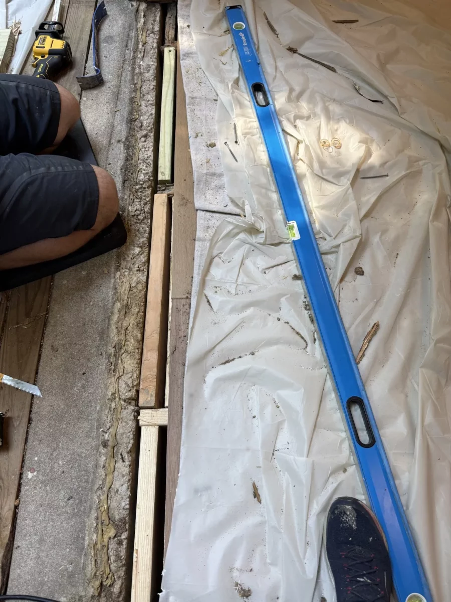 Preparing the rough opening and leveling the sill for a new sliding patio door installation