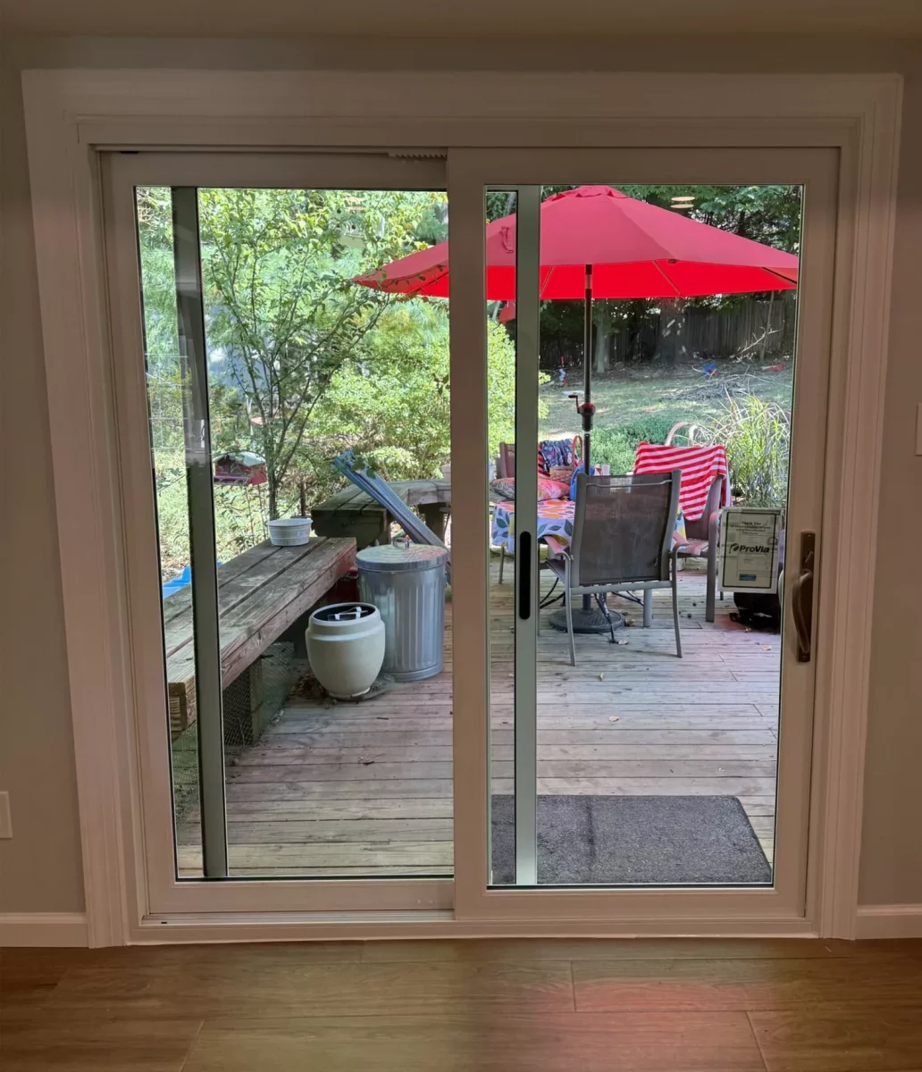 New white sliding patio door with fresh interior trim after replacement, interior view in Silver Spring, MD