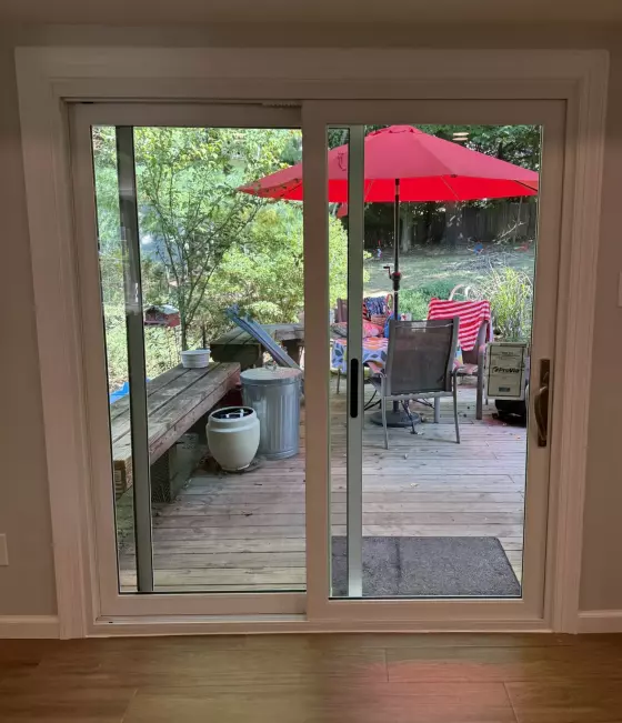 New white sliding patio door with fresh interior trim after replacement, interior view in Silver Spring, MD